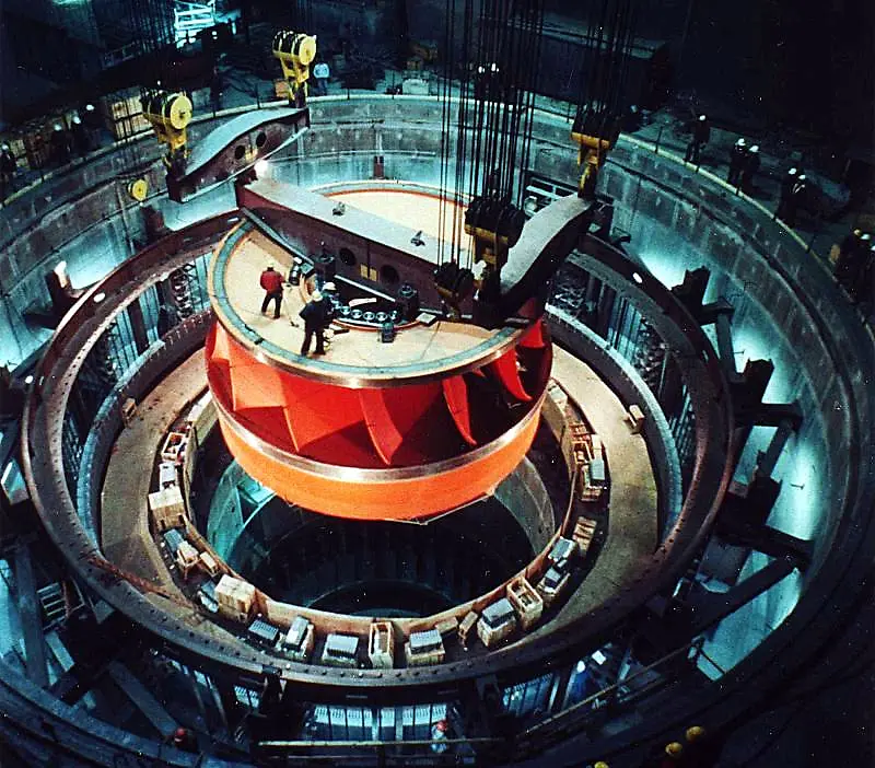 A hydroelectric turbine assembly being lowered into place at Grand Coulee